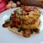  Nidi al forno con funghi piselli e speck 